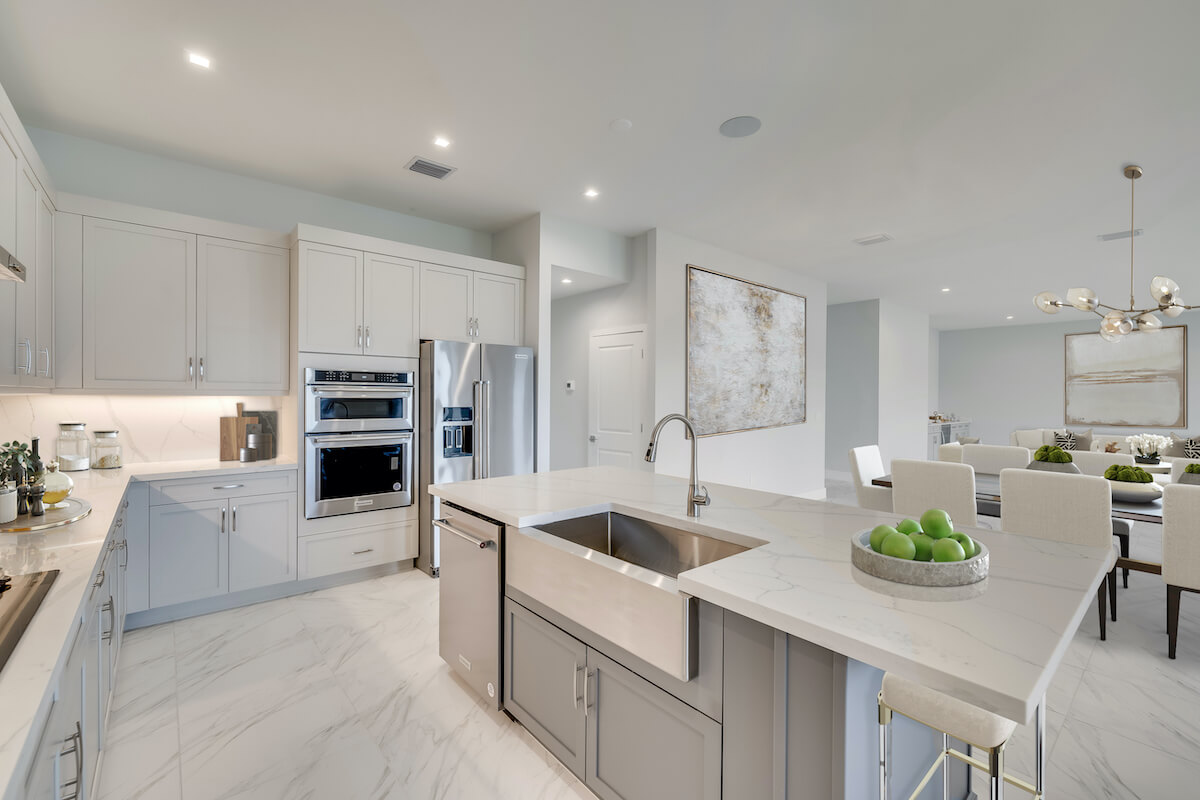 Bright modern kitchen with quartz countertops, stainless steel appliances, and open-concept dining